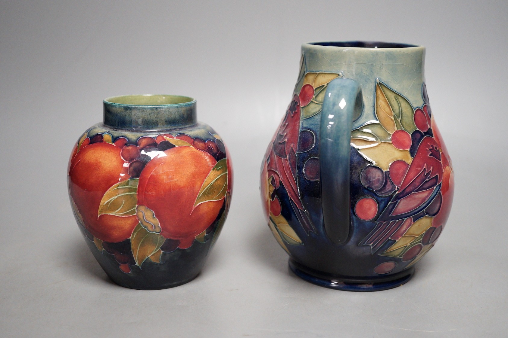 A Moorcroft finch and berry jug and a Moorcroft pomegranate jar, tallest 15cm